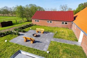 an overhead view of two benches and a dog laying on a patio at Ferienwohnung Landleben am Meer in Bensersiel +77 photos