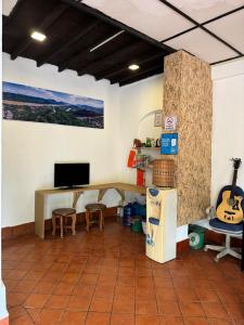 a room with a desk and a television and a table at Lonely Guesthouse in Luang Prabang