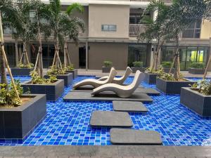 a pool with a slide in the middle of a building at Airport Home Base Trips Getaways 3pax balcony 6g in Manila