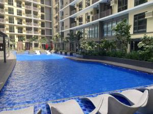 a large swimming pool in the middle of a building at Airport Home Base Trips Getaways 3pax balcony 6g in Manila