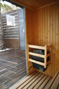 
a wooden bench in front of a wooden door at Hotel Boutique Ses Pitreras in Port des Torrent
