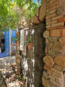 a stone wall with a plant in a pot on it at Casa Olive in San Vito