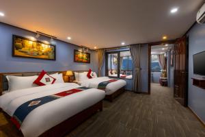 a hotel room with two beds and a television at SaPa Fansipan View Homestay & Trekking in Sa Pa