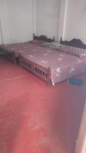 a bed in a room with a red carpet at Bella Casa 26AN in Nuwara Eliya