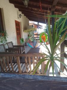 a porch with a wooden bench and a potted plant at Galerija Jovanović in Topola