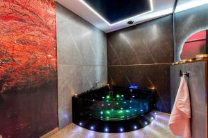 a bathroom with a tub with lights in it at Stacja Galicja Rooms blisko Energylandia in Trzebieńczyce +107 photos
