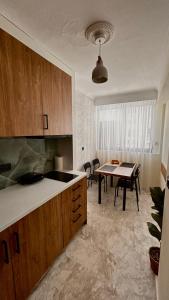 a kitchen with a table and a dining room at Centralsuiteaxd in Alexandroupoli