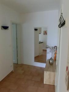 a living room with white walls and a wooden floor at Ferienwohnung Mozart Bayreuth in Bayreuth