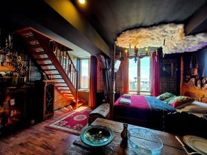 a bedroom with a bed and a wooden table at La Taverne du Sorcier By Primo in Arras