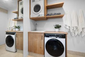 a laundry room with a washer and dryer at Sundaze at Kingy Creek in Kingscliff