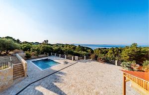 a swimming pool on a patio with a view of the ocean at Beautiful Home In Vela Luka in Vela Luka