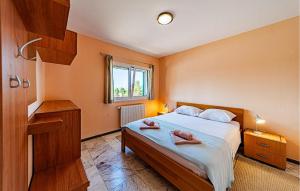 a bedroom with a bed with two towels on it at Beautiful Home In Vela Luka in Vela Luka