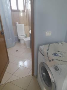 a washing machine in a bathroom with a toilet at Hidden Gem Vlora in Vlorë