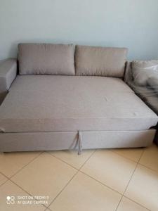 a couch sitting on a floor in a room at Hidden Gem Vlora in Vlorë
