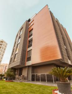 a building with a wooden roof on the side of it at BMK Suites Apartments in Antalya