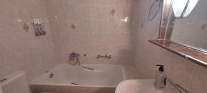 a bathroom with a tub and a toilet and a sink at Harmony 1 in Áyios Spirídhon +13 photos