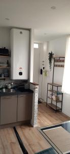 a kitchen with a sink and a counter top at Appartement neuf, porte de Saint-Malo in Saint-Jouan-des-Guérets