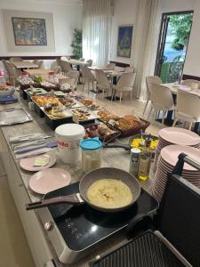a buffet with a lot of food on a table at Hotel Abamar in Rimini +28 photos