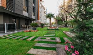 a garden in the middle of a building at BMK APART Otel in Antalya