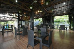 a dining room with chairs and tables and tablesktop at Sanctuary Batulao in Nasugbu