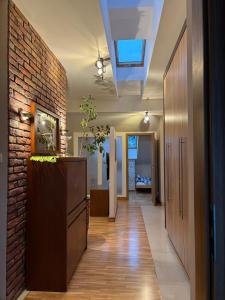 a hallway with a brick wall and a ceiling at Apartament Rodzinny Huberta in Gdańsk