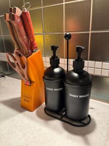 two black bottles sitting on a counter next to a knife block at Apartament Rodzinny Huberta in Gdańsk +36 photos