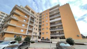 a large apartment building with cars parked in a parking lot at DreamApartment in Deva +2 photos
