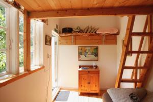 a room with a bunk bed and a ladder at Mormors Bakeri – B&B in Asarum
