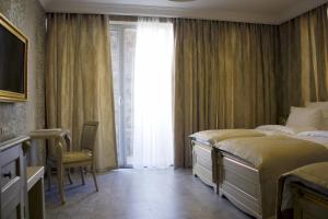 Postel nebo postele na pokoji v ubytování Neapol Boutique Hotel