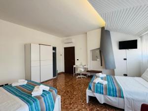 a hotel room with two beds and a desk at MMM HOME Train Station 3 in Mestre