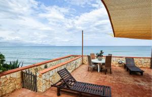 a patio with a table and chairs and the ocean at Amazing Apartment In Trappeto With Wifi in Trappeto +7 photos