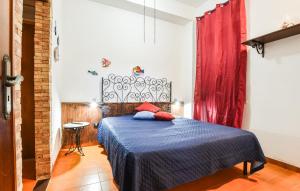 a bedroom with a blue bed with a red curtain at Amazing Apartment In Trappeto With Wifi in Trappeto