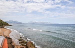 a view of a beach with mountains in the distance at Amazing Apartment In Trappeto With Wifi in Trappeto