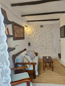 a living room with a couch and a table at Aelia in Ioulis