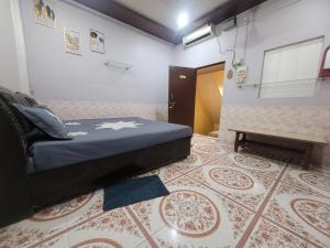 a bedroom with a bed and a table on a rug at Radha Govind stays in Vrindāvan +4 photos
