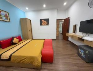 a bedroom with a large bed with a red chair at Dream Hotel in Hanoi