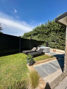 a backyard with a couch and a fence at Maison avec jaccuzzi Aix-en-Provence in Aix-en-Provence