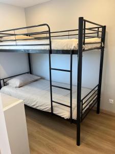 a couple of bunk beds in a room at Maison avec jaccuzzi Aix-en-Provence in Aix-en-Provence