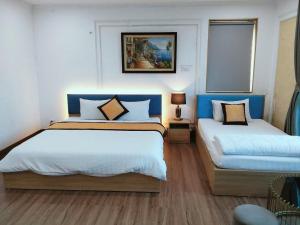 a hotel room with two beds in a room at Dream Hotel in Hanoi