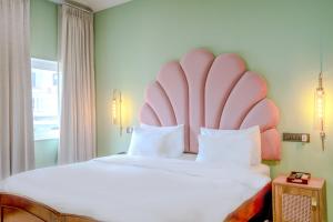 a bedroom with a large bed with a large headboard at Girisadan - A City Centre Boutique Hotel in Jaipur