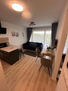 a living room with a couch and a table at Ponton Apartman Alsóőrs in Alsóörs