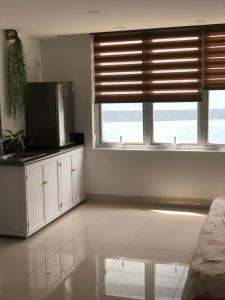 a living room with a window and a microwave at Peaceful Paradise Homestay in Hai Phong