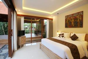 a bedroom with a large bed and a balcony at Pondok Lekad D'ubud Private Pool in Ubud +31 photos