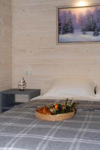 a bedroom with a bed with a bowl of fruit on it at Нанашкові хатки 