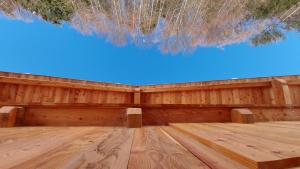 a wooden floor with a blue sky in the background at BATAJA - Dolomites Lodge in Valle di Cadore