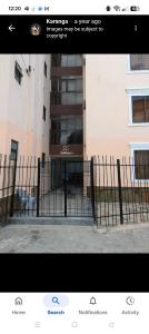 a picture of a fence in front of a building at MJ BRACHA Holiday Vacation Home in Mombasa