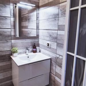 a bathroom with a sink and a mirror at Casale dei Villa villa with pool and private parking in Ciampino +28 photos