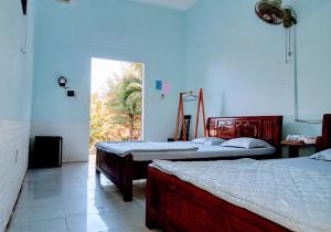 Katil atau katil-katil dalam bilik di Farmstay Đảo Xanh