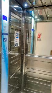 a stainless steel refrigerator sitting inside of a room at Holidays in Martil - Beach, comfort and safety in Martil