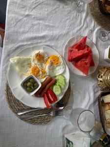 two plates of breakfast food on a table at Nomad place - horse riding tour Son-Kul in Dzhangyaryk